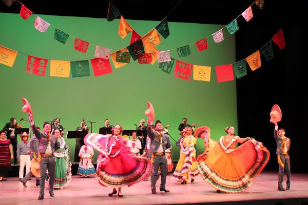 Mexican folkloric dancers and musicians fill the stage