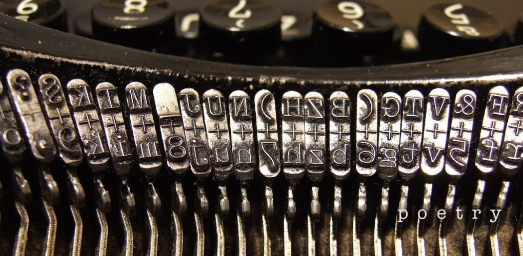 Close up image of old typewriter strikers, with the word 