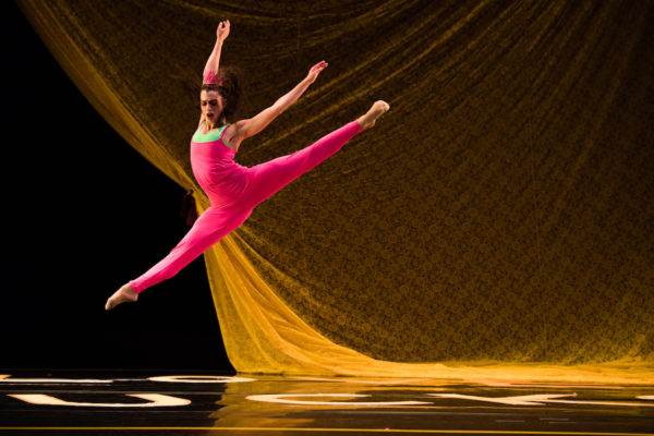 A dancer in pink jumps