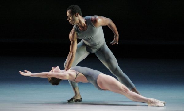 A male dancer hold a stretched out dancer