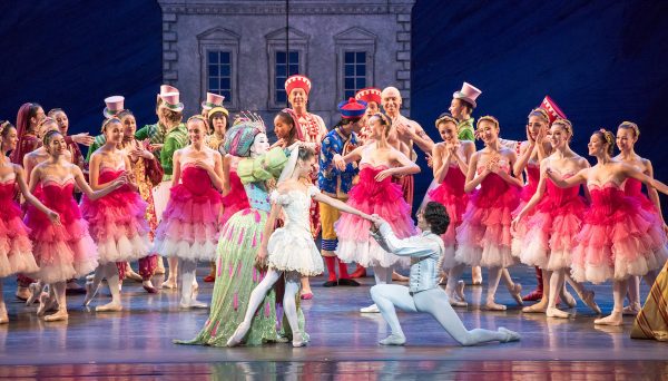 Dancers in pink costumes surround a couple in white in Nutcracker