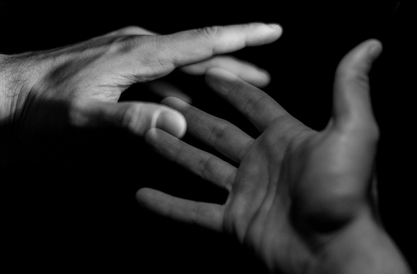 Two hands. Photo by Marco Chilese via Unsplash.