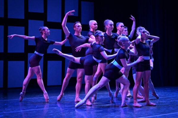 A group of dancers in blue light