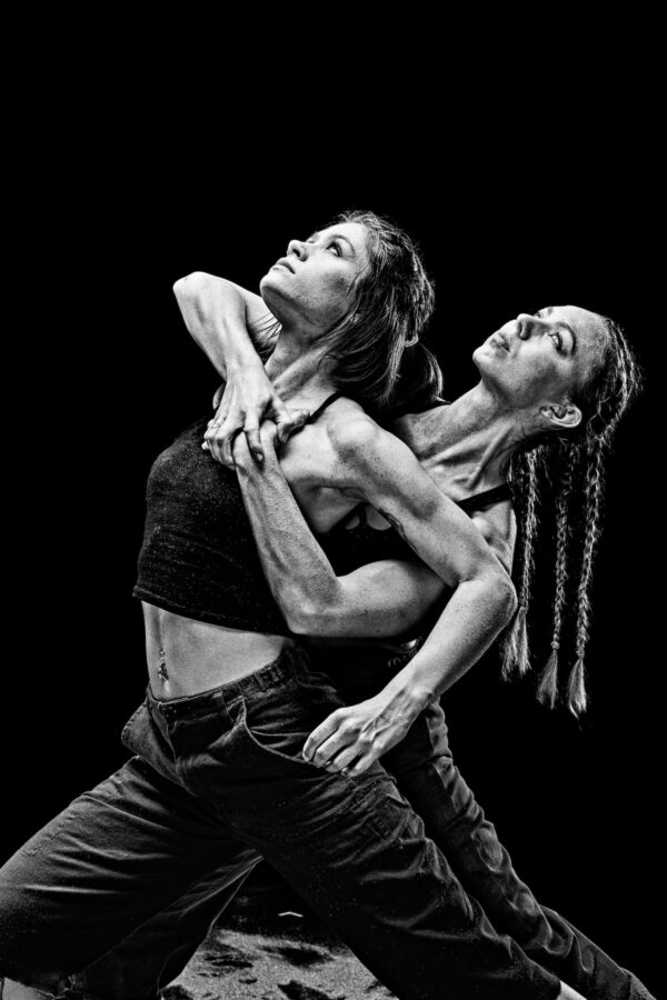 Two female dancers clutch