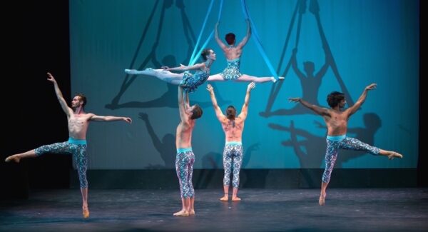 Acrobats suspended by scarves