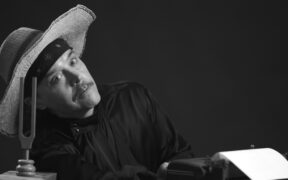 Poet Rich Ferguson has a mustahe and wears an old fashioned hat