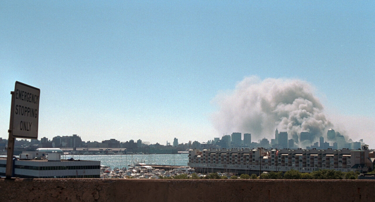 From across the water, smoke is visible rising from the twin towers site.