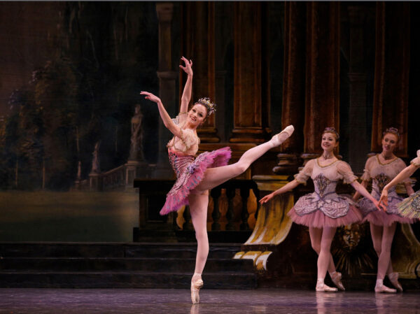 A dancer from the Los Angeles Ballet n a pink skirt in arabesque