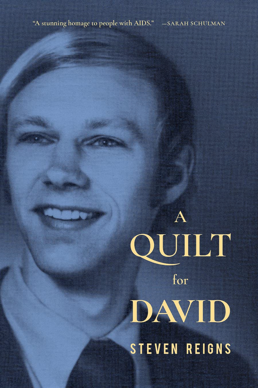 Book cover for A Quilt for David by Steven Reigns; image is a colorized black and white photo--loking vintage, say, 1960s--a smiling young masn with blond hair