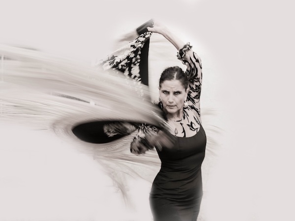 A flamenco dancer swirls a scarf