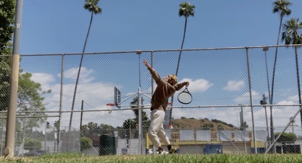 A man hits a tennis ball