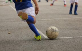 a soccer player getting ready to hit a corner kick