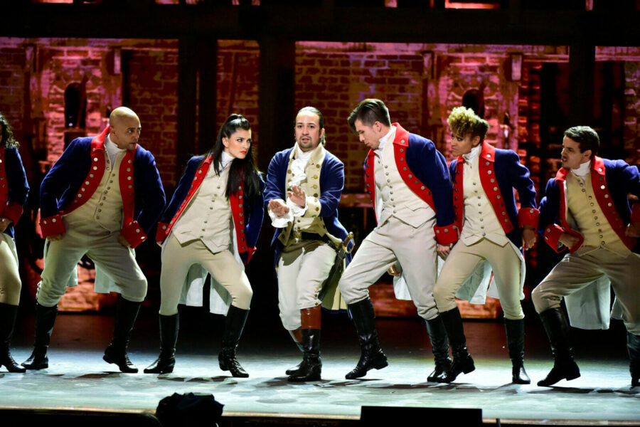 Six actors in old military garb on stage in Hamilton the Musical.