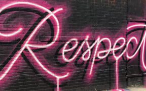 the word Respect painted in neon pink on a wall