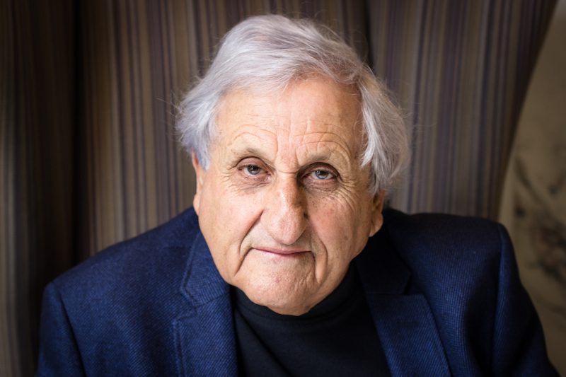 A.B. Yehoshua looks into camera wearing a blue suit.