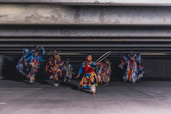 A group of Native American dancers in colorful clothes