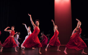 A group of dancers in red