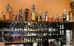In the main dining room, a lengthy line of whimsical calacas, the skeleton figures popular in Dia de los Muertos celebrations and altars, line the bar.