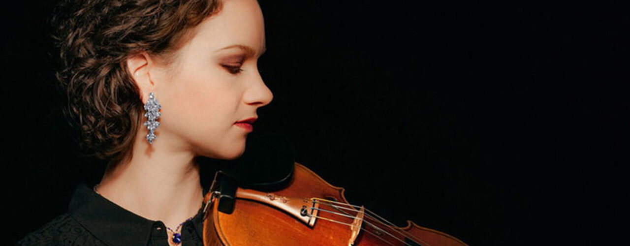 A photo of violinist Hilary Hahn holding her violin