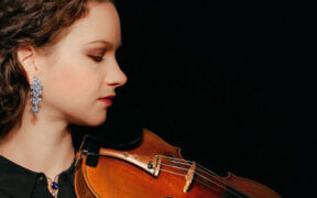 A photo of violinist Hilary Hahn holding her violin