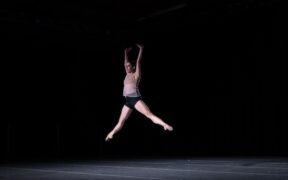 A female dancer leaps in the air