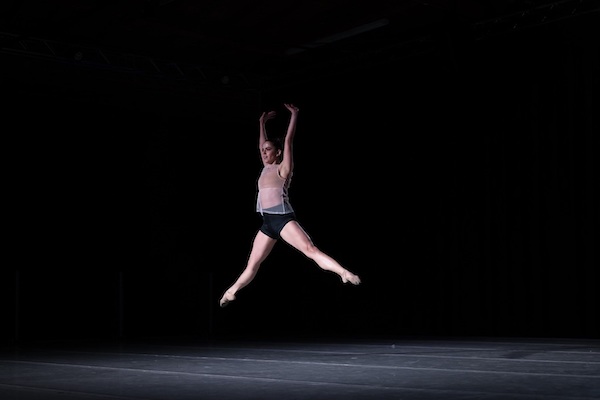 A dancer leaps in the air