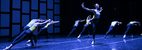 a group of ballet dancers in blue light