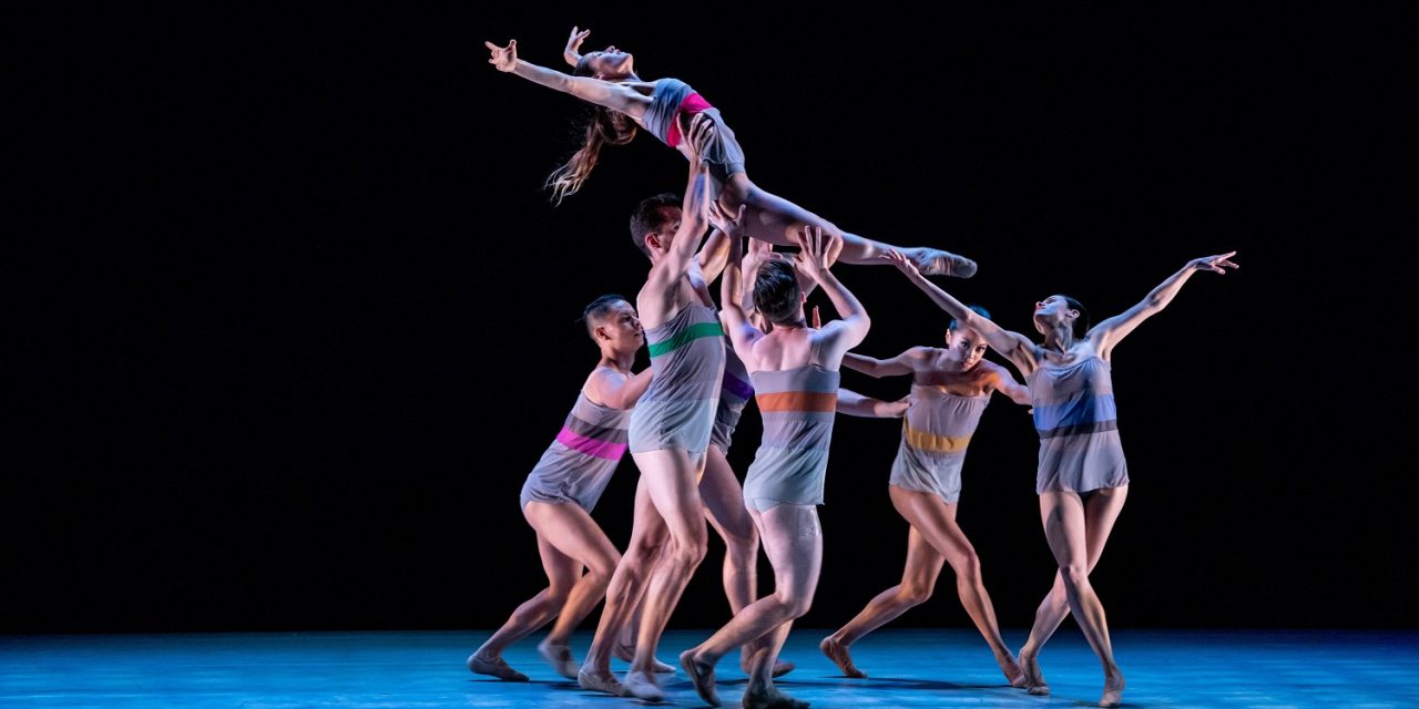 a group of dancers carry a single dancer