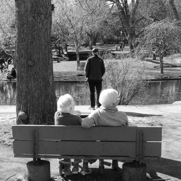 two elderly ladies on a park bench