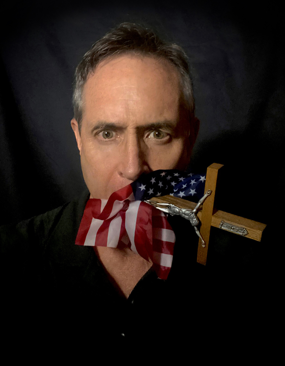 "Shoved down our throats" is a self portrait of the author with an American flag and crucifix in his mouth