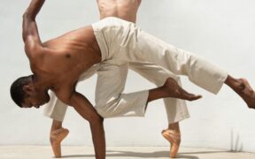 Two male dancers in white pants