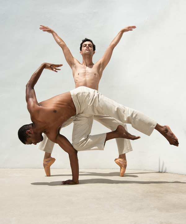 Two male dancers in white pants