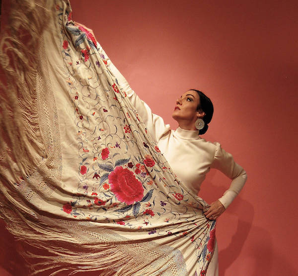 A flamenco dancer in white and red