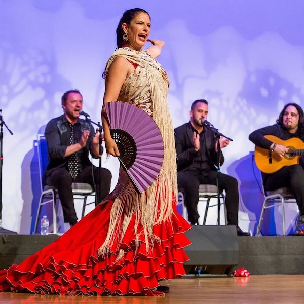 A flamenco dancer and musicians