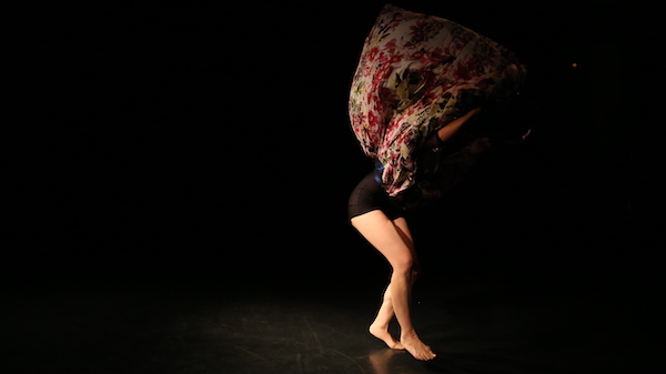A dancer's colorful skirt flies above her head