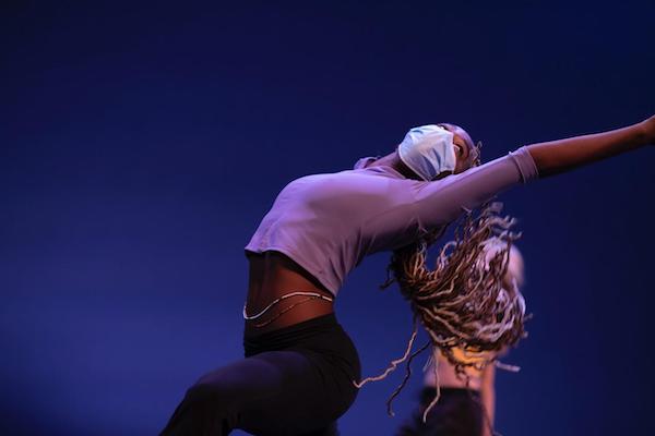 A dancer in fuschia bends backwards
