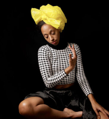 Natasha Marin, the beautiful Black woman author and artist, in a yellow head wrap