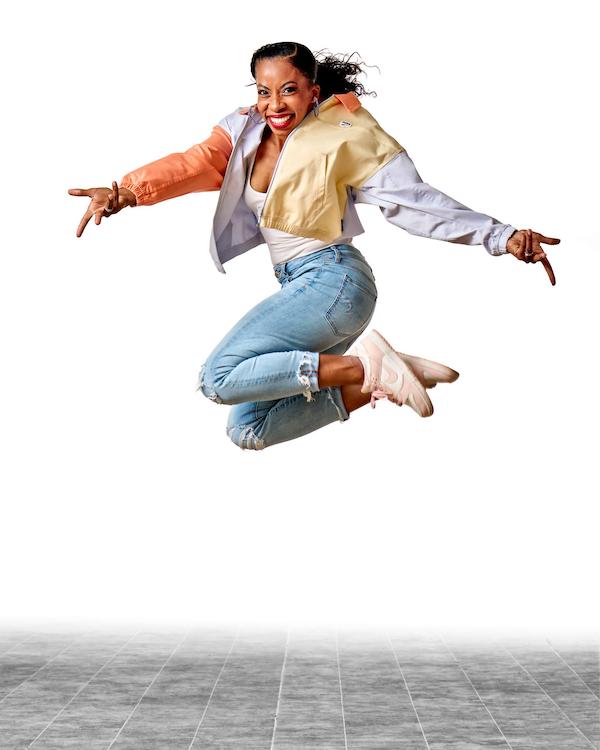 A dancer in jeans leaps in the air