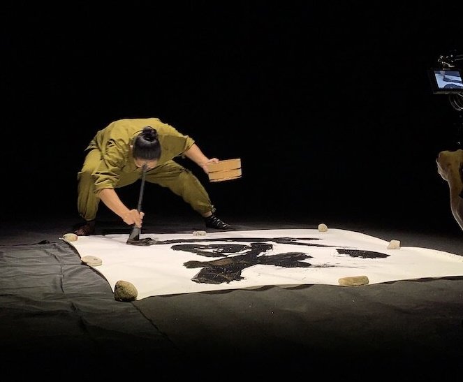 A Japanese dancer does calligraphy