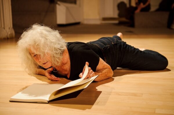 Woman on ground with book