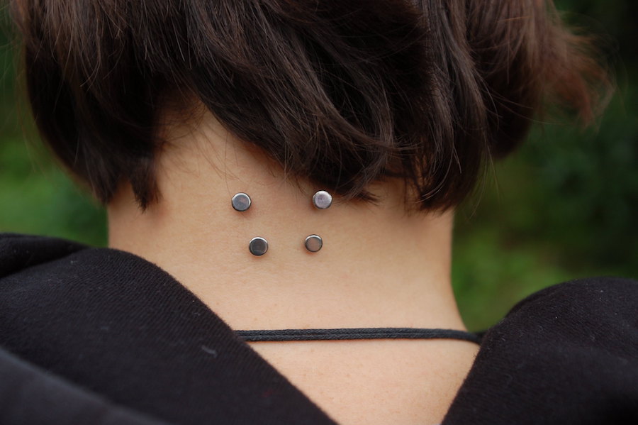 a photo of unusual piercings on the neck