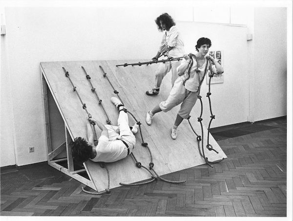 Performers on roped ramp in a Simone Forti performance
