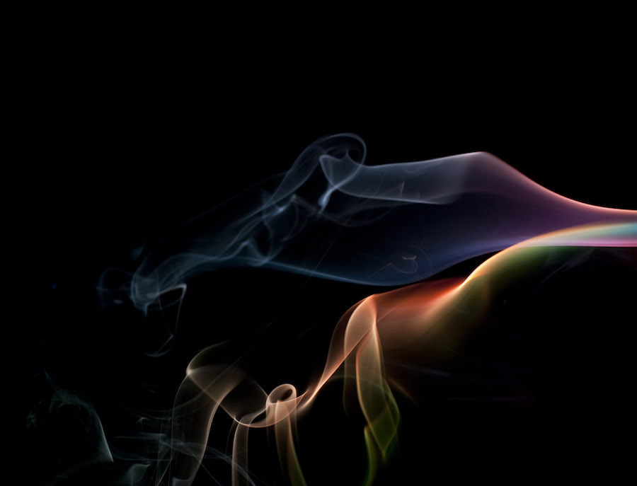 a colorful cloud of smoke vapour on black