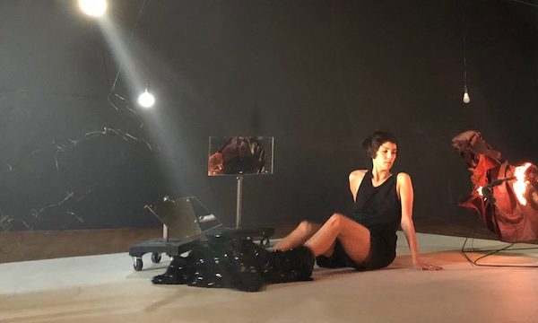 A dancer sits on the floor