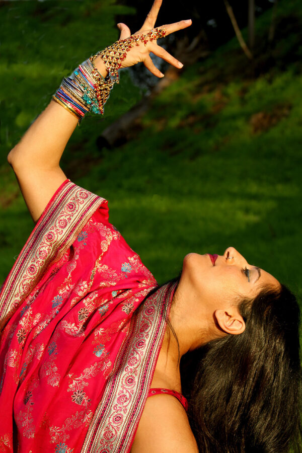 Woman in sari bending backwards