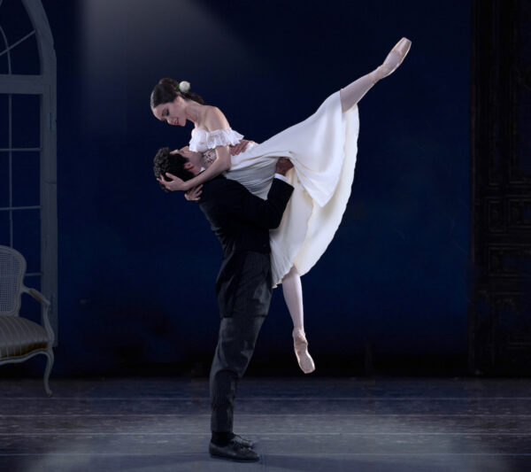 A man lifts a woman in white in Lady of the Camellias by the Los Angeles Ballet