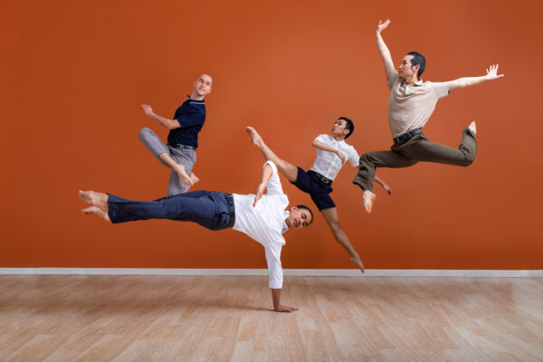 Four male dancers jumping