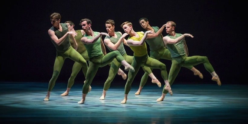 A group of male dancers in green