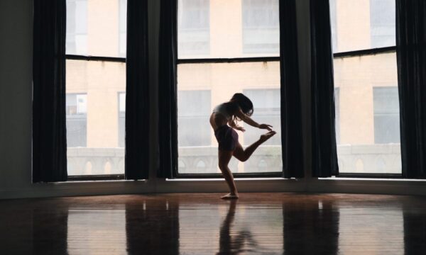 A dancer backlit against a window