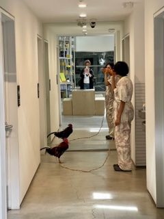 Carmen Argote holding a chicken on a leash